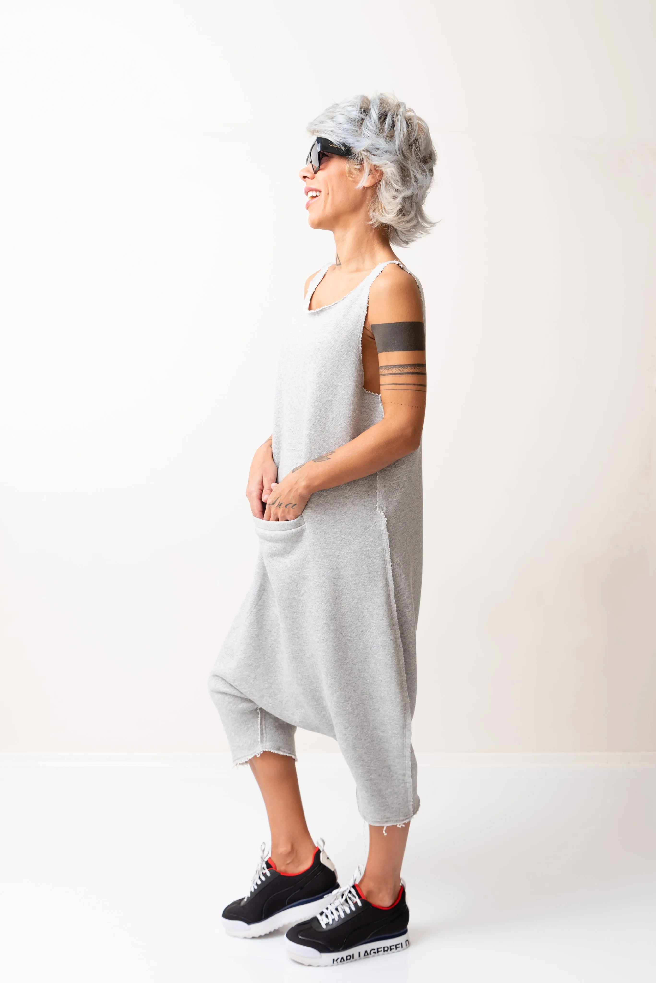 Grey Oversized Sleeveless Jumpsuit Paired with a Top with Long Sleeves