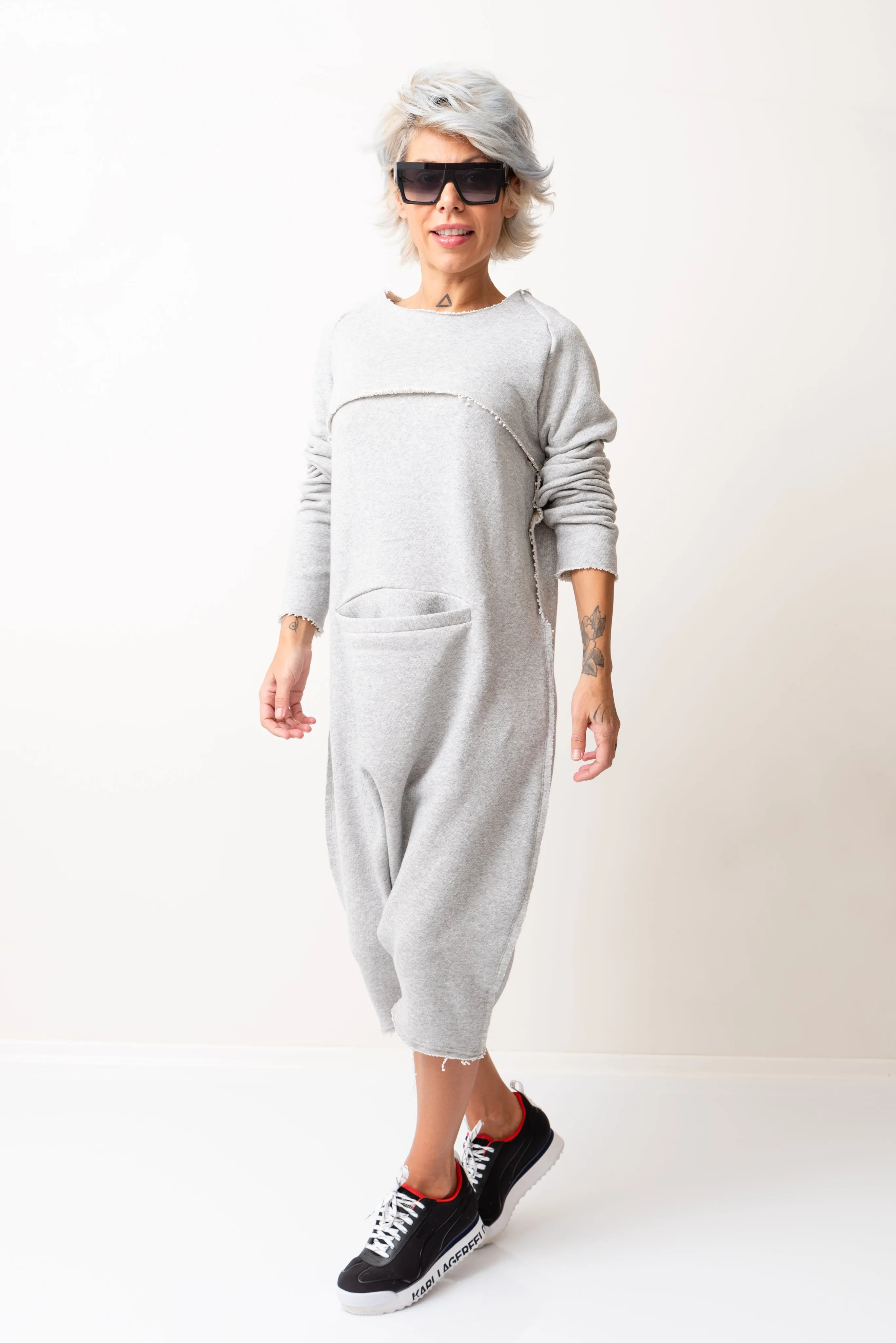 Grey Oversized Sleeveless Jumpsuit Paired with a Top with Long Sleeves