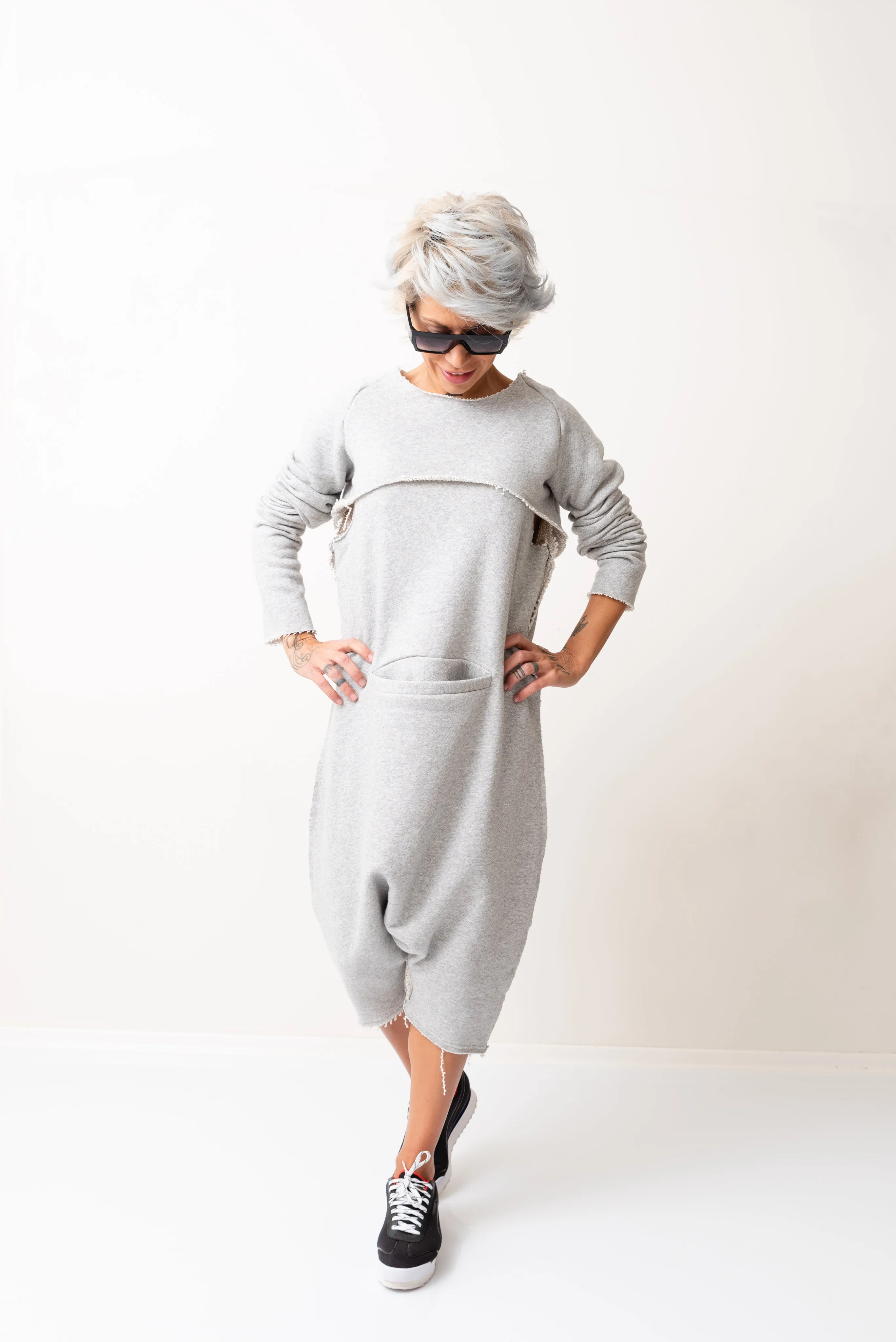 Grey Oversized Sleeveless Jumpsuit Paired with a Top with Long Sleeves