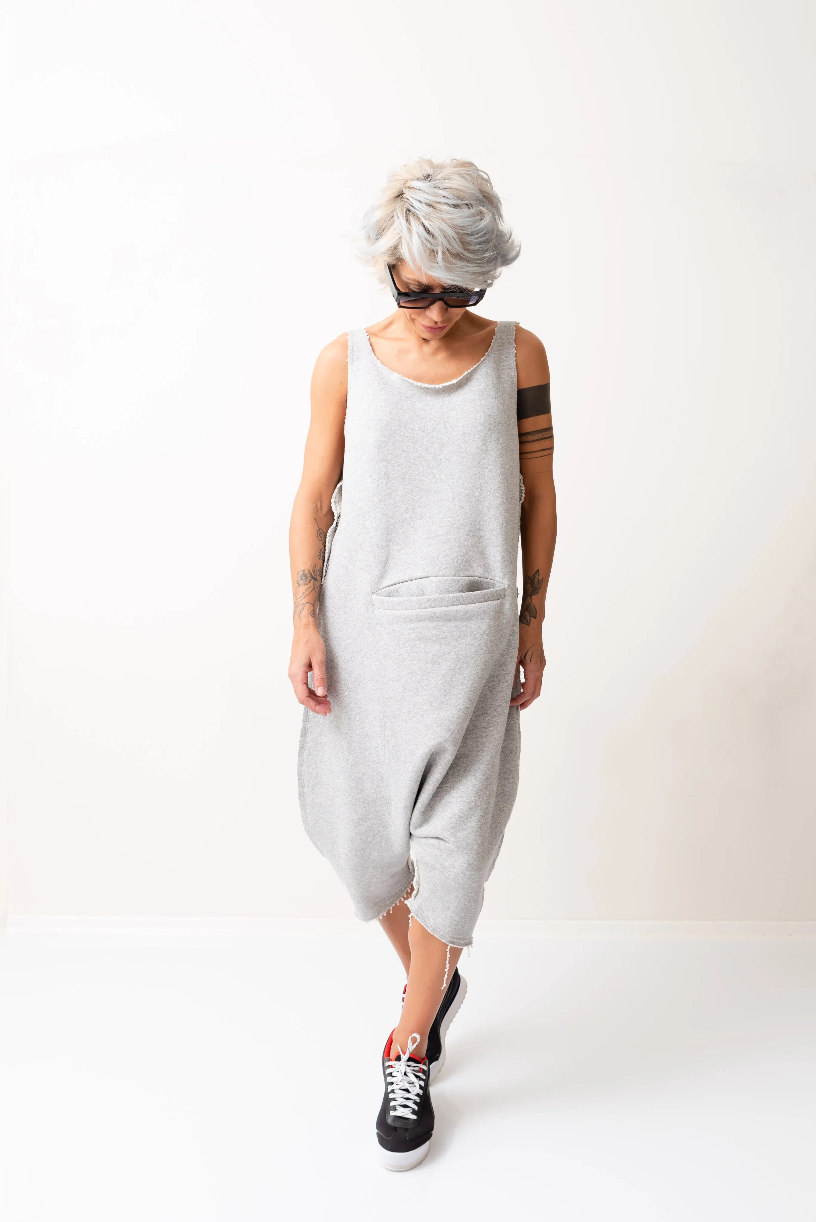 Grey Oversized Sleeveless Jumpsuit Paired with a Top with Long Sleeves