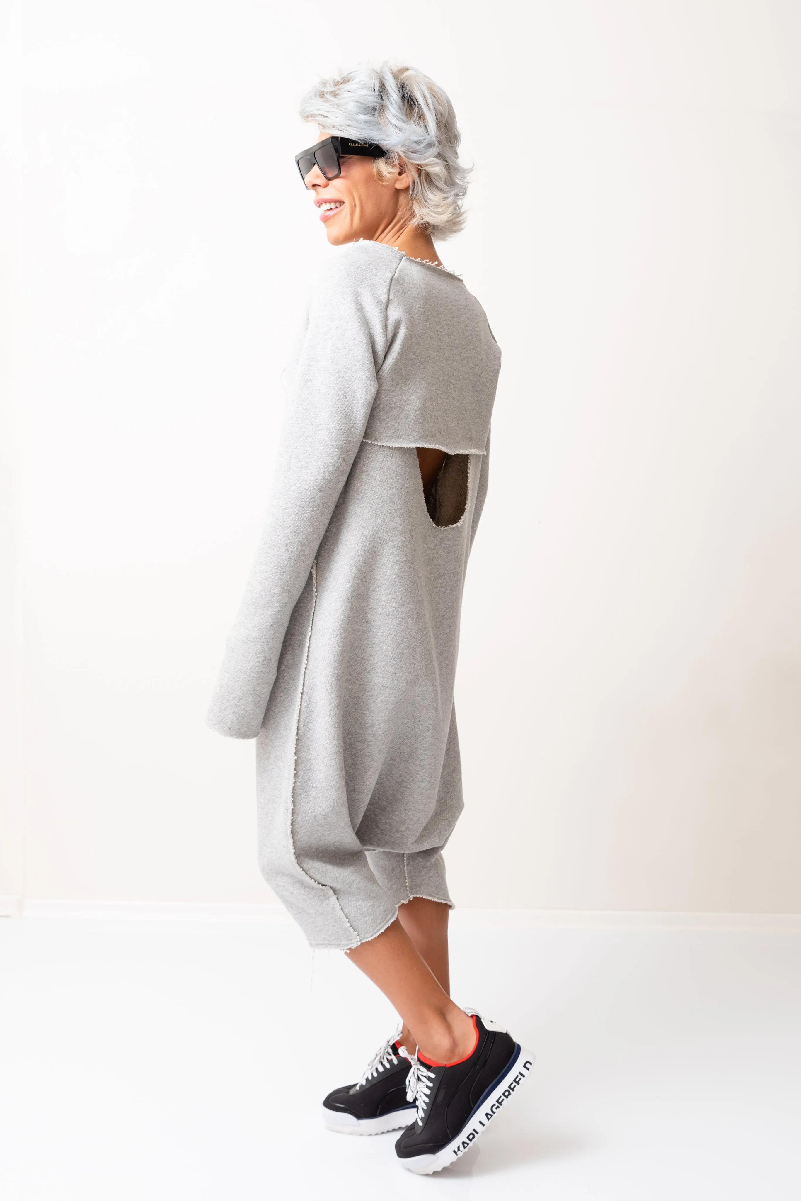 Grey Oversized Sleeveless Jumpsuit Paired with a Top with Long Sleeves