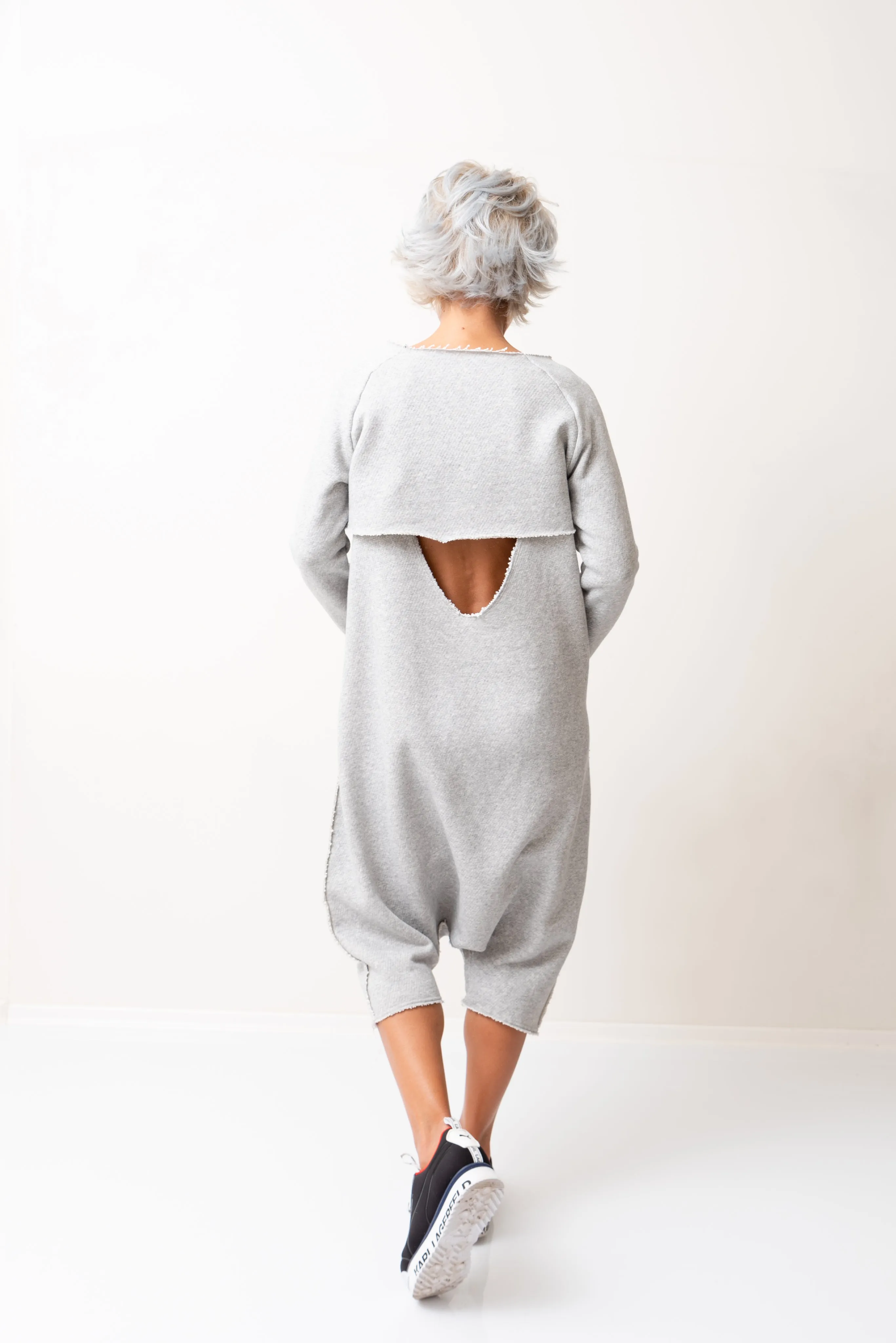 Grey Oversized Sleeveless Jumpsuit Paired with a Top with Long Sleeves