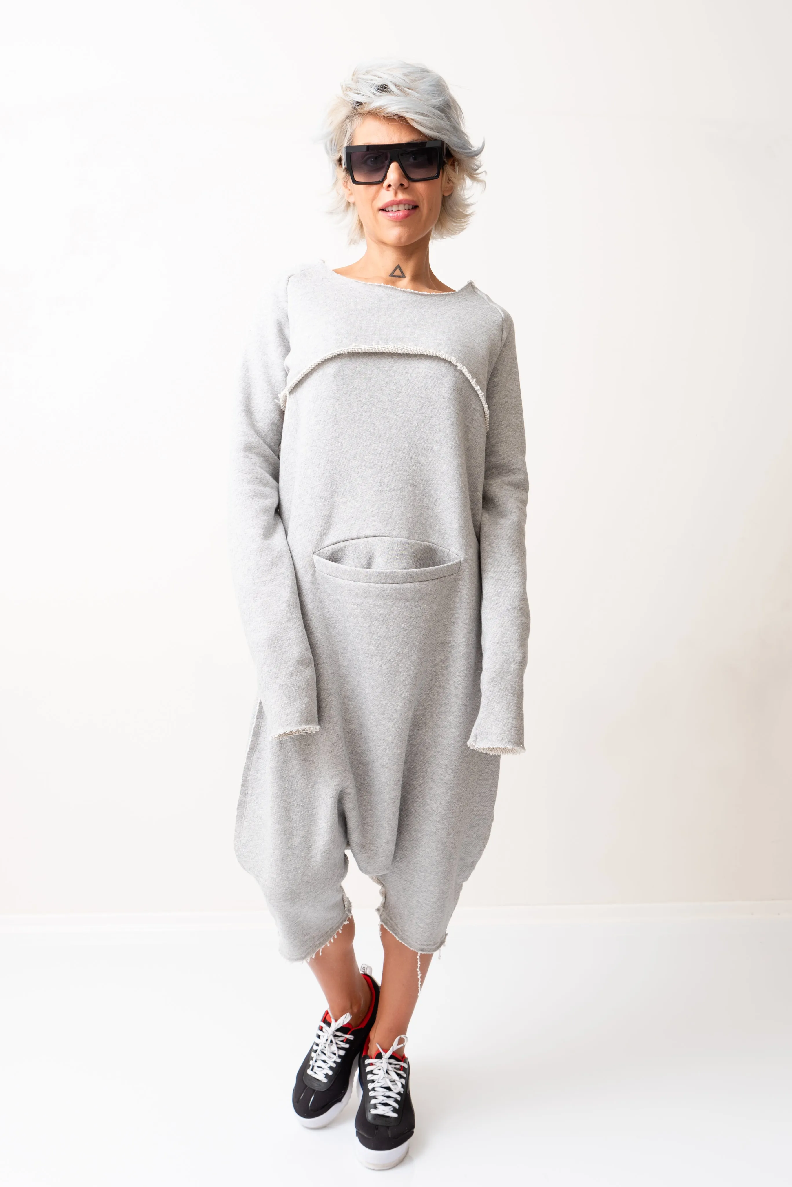 Grey Oversized Sleeveless Jumpsuit Paired with a Top with Long Sleeves